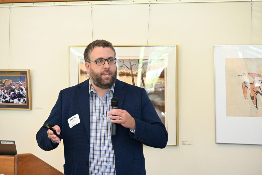 Jacob Serfling of the Midwest Decarbonization Coalition discusses the budget and health benefits of building electrification at the September 25 Iowa School Energy Conference in Ames.