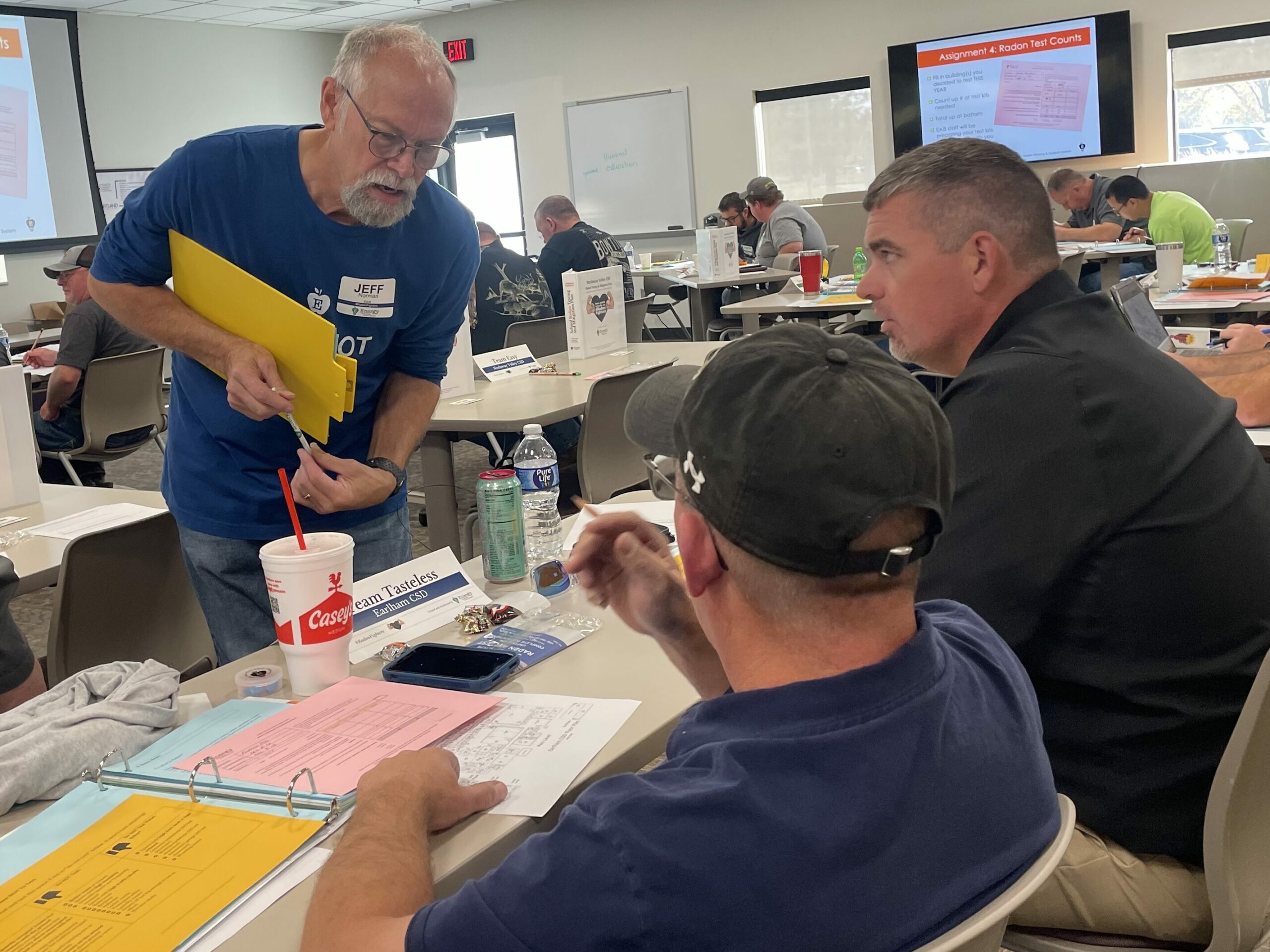 EAIS Radon Rep Jeff Norman coaches school staff during a 2024 radon test training.