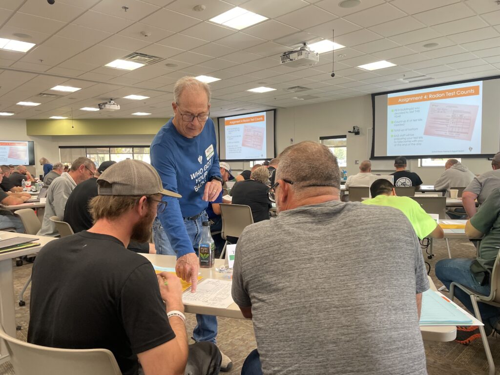 EAIS Radon Rep Keith Turner advises school staff during a radon test training.